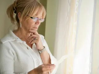 Senior adult in thoughtful reflection at home